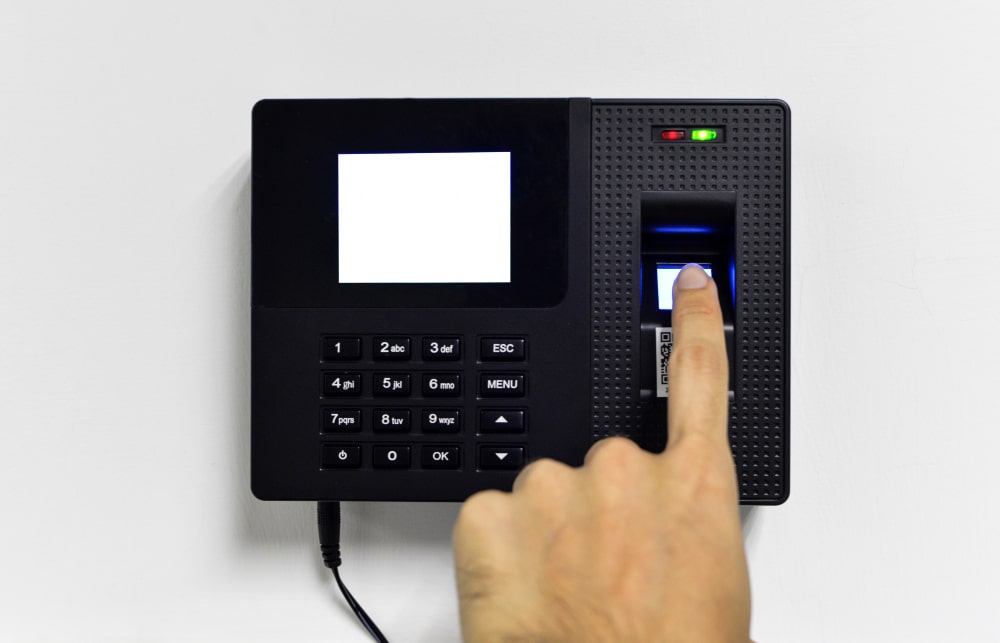 Fingerprint being scanned on a biometric attendance reader